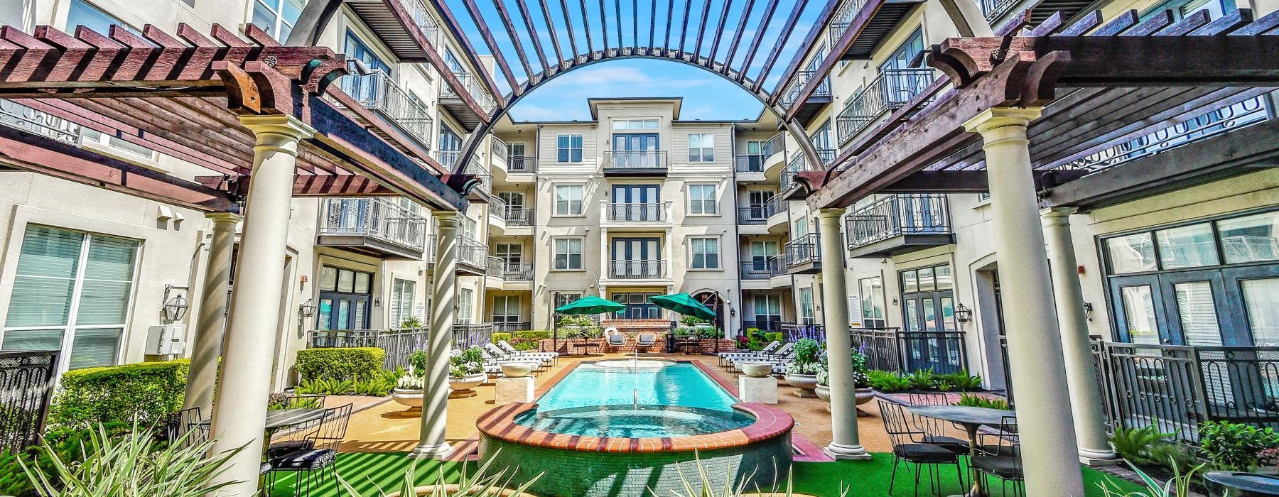 a courtyard with a fountain and plants